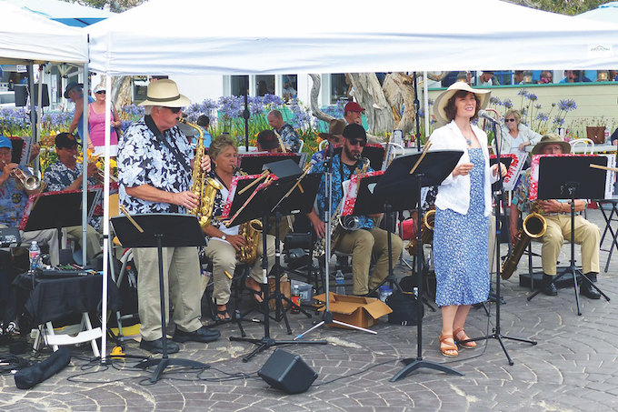 Laguna Jazz Band, under the direction of Lynn Olinger, (pictured playing the saxophone), serenade at the 2021 Fête de la Musique at Main Beach 2