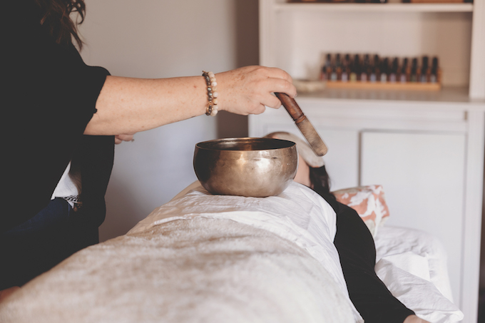 Walker-Collins, owner of Mystic Reiki & Wellness conducts a reiki session_credit Emily McAllister Photography