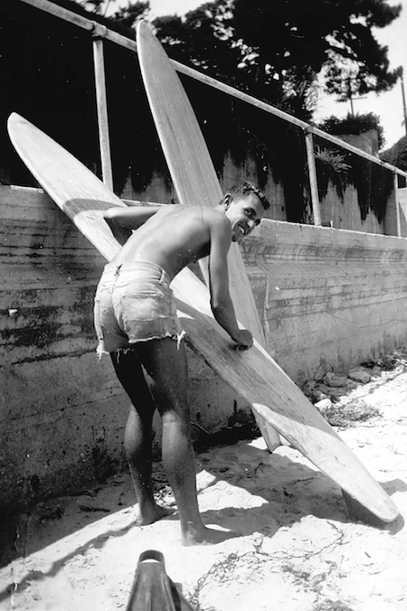 Dick Metz waxing his Velzy board in 1952_credit by Surfing Heritage and Culture Center/Dick Metz Collection/shacc.org